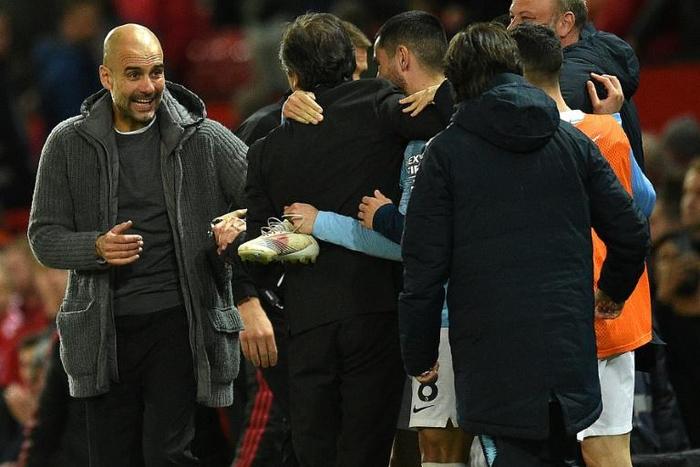 'Keep calm': Pep Guardiola reacts with his players and staff after Wednesday's 2-0 win