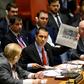 Venezuelan Foreign Minister Jorge Arreaza (C) shows a newspaper as he speaks to a United Nations Security Council meeting on the situation in Venezuela on January 26, 2019