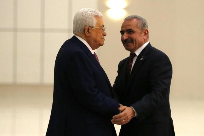 Analysts say Palestinian president Mahmud Abbas (L) retains the real decision making power despite prime minister Mohammad Shtayyeh (R) forming a new government
