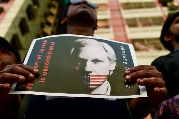 For many, "freedom of speech is unconditional," as the placard says, and that includes for WikiLeaks founder Julian Assange