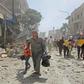 Members of the Syrian Civil Defence (known as the White Helmets) carry a wounded man on a stretcher after a reported air strike Maaret al-Numan in the jihadist-held Idlib province as others flee the scene