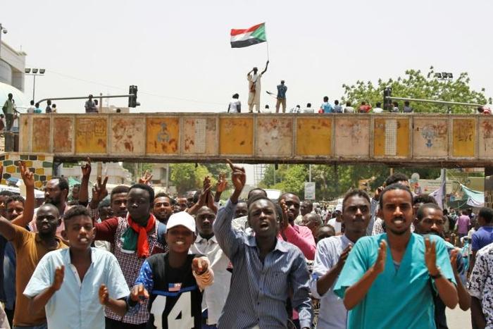Sudanese chant slogans as they gather during a demonstration outside the army headquarters in Khartoum on May 2, 2019