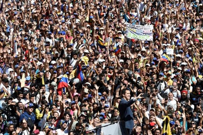 Venezuela's opposition leader Juan Guaido takes a selfie in front of a huge adoring crowd in Caracas