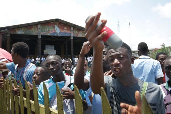 Anger: A student shows a tear gas canister thrown by riot police during a rally to protest at changes in the university grant process