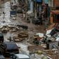 The unusually heavy rain that struck the Rio de Janeiro region triggered flash flooding that turned some streets into raging rivers, gushing through ground-level homes and businesses and weakening structures