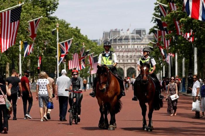 Mounted police officers patrol near Buckingham Palace, with both the US flag and the Union Jack flying as London and the royal family prepare a bit warily for a pomp-filled visit by US President Donald Trump