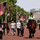 Mounted police officers patrol near Buckingham Palace, with both the US flag and the Union Jack flying as London and the royal family prepare a bit warily for a pomp-filled visit by US President Donald Trump
