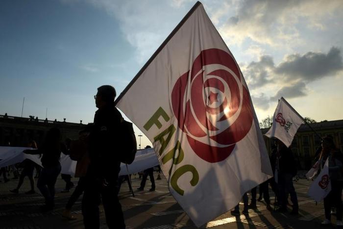 People hold flags of the Common Alternative Revolutionary Force (FARC) party during a protest against a reform proposed by the government for the Special Jurisdiction for Peace (JEP) in Bogota, on March 13, 2019.