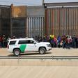 Central American migrants are detained by US Customs and Border Patrol agents at the border wall in Ciudad Juarez, Mexico, on May 7, 2019