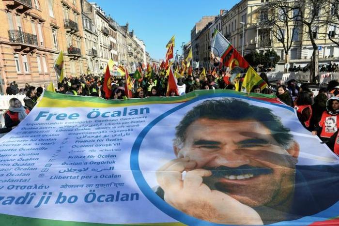 People march with a giant banner reading "Free Ocalan" during a demonstration in Strasbourg, eastern France, on February 16, 2019, to mark 20 years since the arrest of Kurdish leader Abdullah Ocalan, who is jailed in Turkey