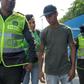Colombian police officers escort a member of Venezuela's armed forces (C) who deserted to Colombia, in Cucuta, on February 25, 2019 -- Colombian officials say 326 soldiers have deserted so far
