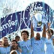 Manchester City's Belgian defender Vincent Kompany raises the Premier League trophy