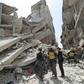 Members of the "White Helmets" rescue group search the rubble of a collapsed building after a previous strike in Idlib's Jisr al-Shughur on Wednesday