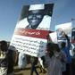 Sudanese protesters carry pictures of fellow demonstrators killed in clashes with security forces