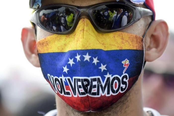 "We'll be back" reads the mask on this demonstrator at the Tienditas International Bridge in Cucuta, Colombia ahead of trying to cross humanitarian aid over the border into Venezuela