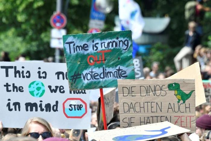 Young demonstrators urged their elders to treat climate change with greater urgency, with one banner held aloft in Berlin reminding them that "the dinosaurs also thought they had time" before they were wiped out