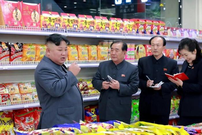 This undated picture released by North Korea's official Korean Central News Agency (KCNA) shows North Korean leader Kim Jong Un (L) visiting a department store