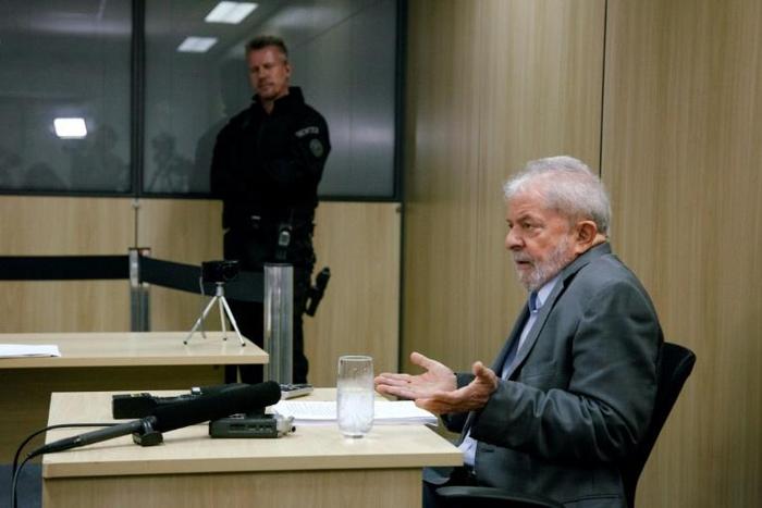 Former Brazilian President Luiz Inacio Lula da Silva (R) gestures during an interview with newspapers El Pais and Folha de Sao Paulo