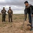 Men and boys suspected of being Islamic State fighters wait to be searched by members of the Kurdish-led Syrian Democratic Forces after leaving the IS group's last holdout of Baghouz on February 27, 2019