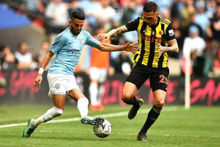 Manchester City's Algerian midfielder Riyad Mahrez (L) runs at Watford defender Jose Holebas during the FA Cup final