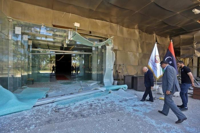 Sadeq al-Keheli (L), interim speaker for a faction of Libyan parliamentarians opposed to strongman Khalifa Haftar, inspects damage at a hotel serving as a HQ in Tripoli