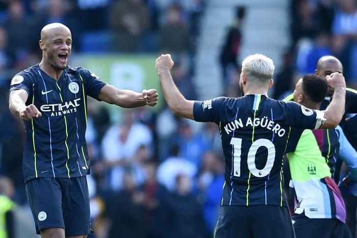 Champions again: Vincent Kompany and Sergio Aguero celebrate their fourth Premier League title with Manchester City