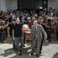 Nantes' French defender Nicolas Pallois (C-L), Emiliano Sala's brother Dario (L) and their father Horacio Sala (R-back), along with relatives and friends carry the late footballer's coffin the funeral service in Progreso, Argentina