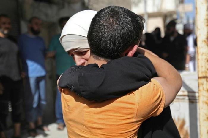 Prisoners held by the Syrian government reunite with relatives during a prisoner exchange between the Syrian government and Hayat Tahrir al-Sham (HTS) in the countryside of the rebel-held Idlib province on May 17, 2019.