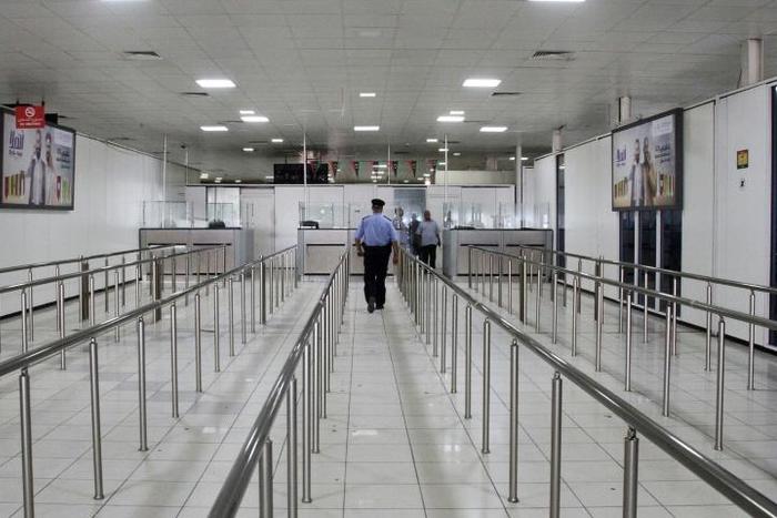 A Libyan policeman walks in the empty Mitiga International Airport in September last year, when the facility was closed by an earlier round of militia clashes