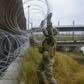 US troops lay concertina wire along the Gateway International Bridge in Brownsville, Texas