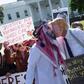 Demonstrators dressed as Saudi Crown Prince Mohammed bin Salman and US President Donald Trump pretend to kiss in a demonstration outside the White House in October 2018