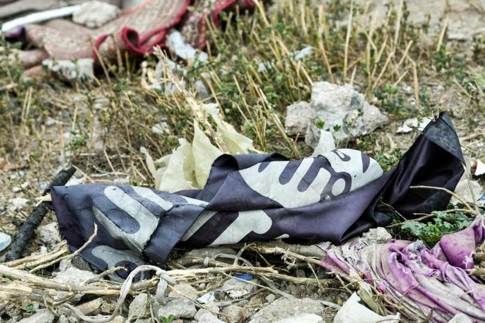 A discarded Islamic State group flag in Baghuz, the village where the last vestiges of the jihadists' self declared caliphate collapsed last month