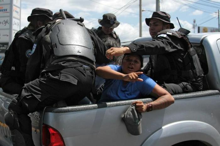 Nicaraguan riot police officers with two people arrested; Canada says it has suspended foreign aid to the troubled Central American country