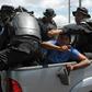 Nicaraguan riot police officers with two people arrested; Canada says it has suspended foreign aid to the troubled Central American country