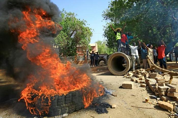 Sudanese protesters block one of Khartoum's main thoroughfares, Nile Street, with burning tyres as they keep up their campaign for civilian rule