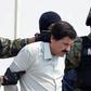 Mexican drug trafficker Joaquin Guzman Loera, aka "El Chapo" Guzman, is escorted by marines February 22, 2014 after his arrest in Mexico