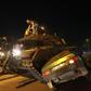 Turkish pro-regime supporters climb onto a tank as it runs over a car during a protest against the military in Ankara on July 16, 2016