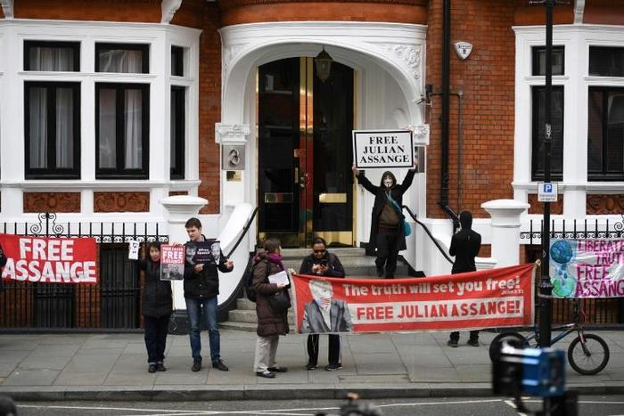 Supporters of WikiLeaks founder Julian Assange display banners and placards as they gather outside the Ecuadorian Embassy in London, where Assange has been living for more than six years and will meet with an independent rights expert