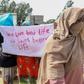 Migrants get their message across during the UN head's visit Thursday