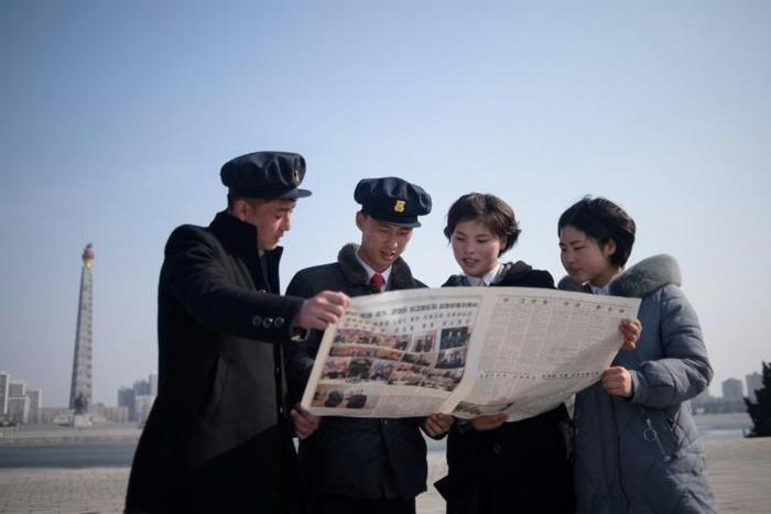 North Korean students read the newspaper coverage of Kim Jong Un's summit with US President Donald Trump