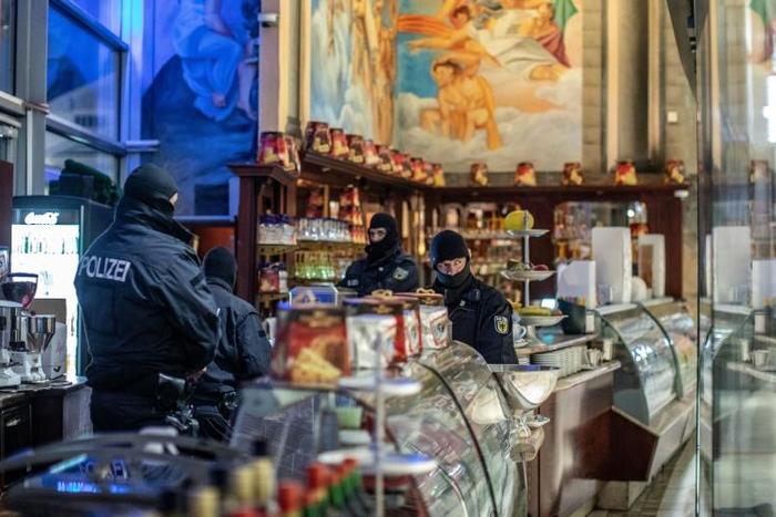 Ninety mobsters from the Calabrian 'Ndrangheta mafia were arrested in December in six different countries, in raids involving hundreds of police officers. Shown here is a raid in a cafe in Duisberg, Germany
