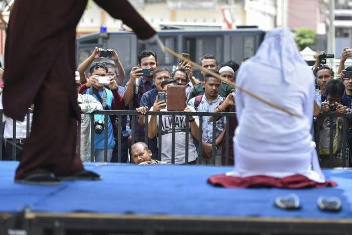 Twelve people were flogged in Aceh province for being found with a member of the opposite sex who wasn't a relation or having intimate relations outside marriage