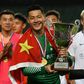 Shandong Luneng's Wang Dalei celebrates with the trophy after his team won the final of the Lunar New Year Cup football tournament in Hong Kong