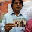 A supporter of Jadhav holds a photograph of himself and the alleged spy along with other friends from the Mumbai neighbourhood where they all grew up