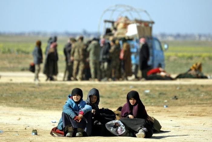 At least 300 women and children, mostly Iraqi, had slept amid the desert scrubs after escaping the Islamic State group's final redoubt of Baghouz in eastern Syria