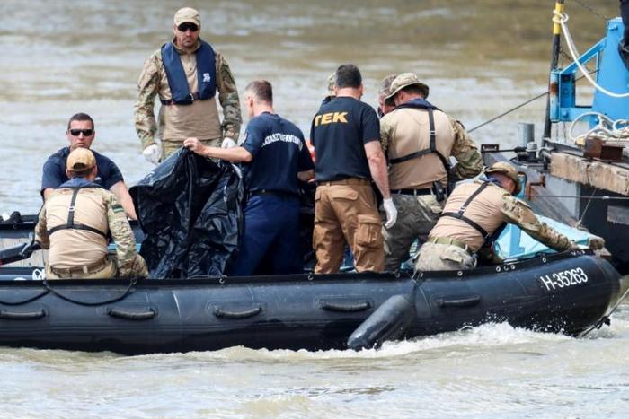 International divers and experts are assessing ways of hoisting the submerged boat or searching for bodies presumed to be stuck inside