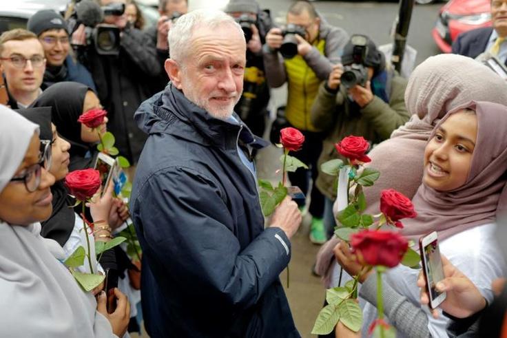 Opposition Labour Party leader Jeremy Corbyn holds a rose as he arrives at Finsbury Park mosque in north London to mark national 'Visit my Mosque Day' on March 3, 2019