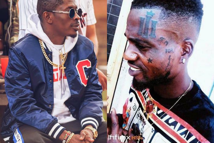 Shatta Wale fan tattoos Reign album symbol on his face