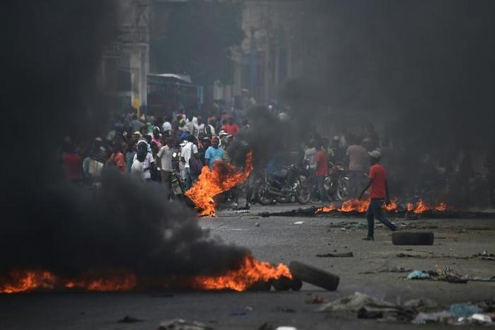 Demonstrators set tire barricades ablaze on the fourth day of protests in Port-au-Prince demanding the resignation of Haitian President Jovenel Moise