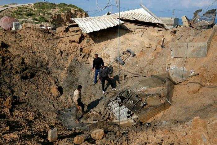 Palestinians check the site of an Israeli air strike in the southern Gaza Strip March 7, 2019